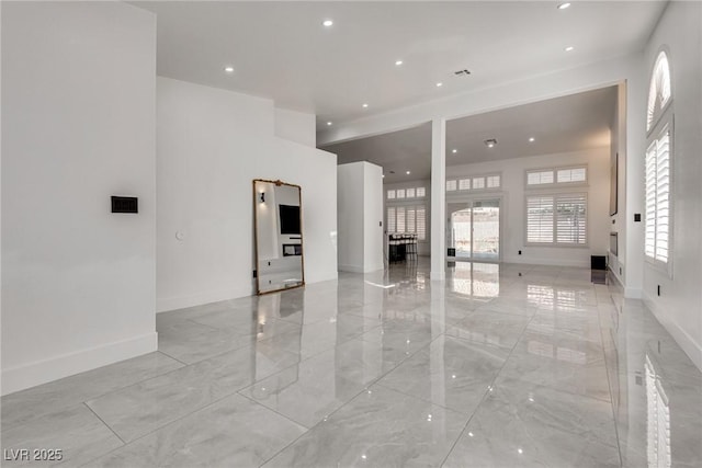 825 Royal Moon Ave, Las Vegas, NV 89123 - unfurnished living room with recessed lighting and light marble finish flooring