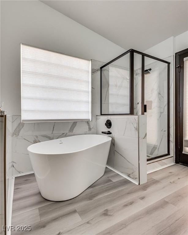 825 Royal Moon Ave, Las Vegas, NV 89123 - full bathroom featuring a marble finish shower, a freestanding bath, and wood finished floors