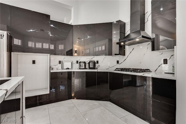 825 Royal Moon Ave, Las Vegas, NV 89123 - kitchen with wall chimney range hood, stainless steel gas cooktop, light countertops, and modern cabinets