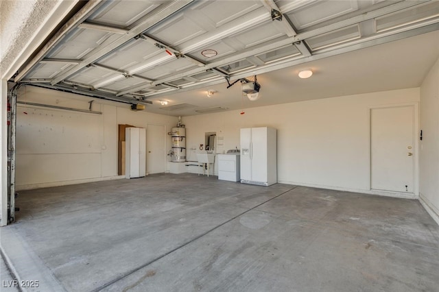 825 Royal Moon Ave, Las Vegas, NV 89123 - garage with white refrigerator with ice dispenser, a garage door opener, and washing machine and dryer