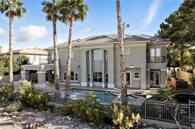 9408 Players Canyon Ct, Las Vegas, NV 89144 - back of property featuring a balcony, a patio, stucco siding, and french doors