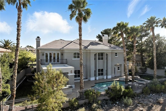 9408 Players Canyon Ct, Las Vegas, NV 89144 - back of property featuring a chimney, stucco siding, french doors, and a patio area