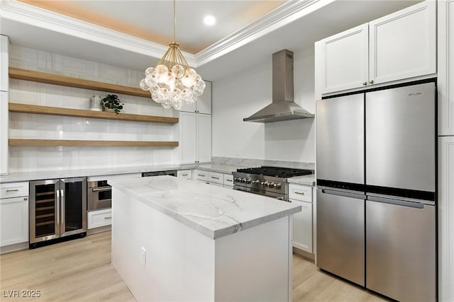 9408 Players Canyon Ct, Las Vegas, NV 89144 - kitchen featuring stainless steel appliances, wall chimney range hood, beverage cooler, a center island, and light wood-type flooring