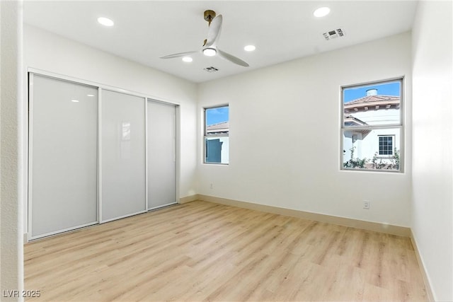 9408 Players Canyon Ct, Las Vegas, NV 89144 - unfurnished bedroom with multiple windows, wood finished floors, a closet, recessed lighting, and ceiling fan