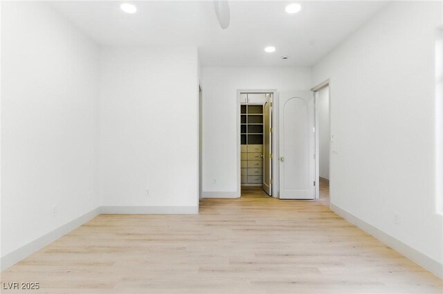 9408 Players Canyon Ct, Las Vegas, NV 89144 - unfurnished bedroom featuring recessed lighting, light wood-style floors, a walk in closet, and a closet