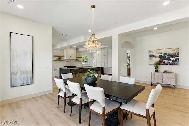 9408 Players Canyon Ct, Las Vegas, NV 89144 - dining space with arched walkways, light wood-type flooring, a chandelier, and recessed lighting