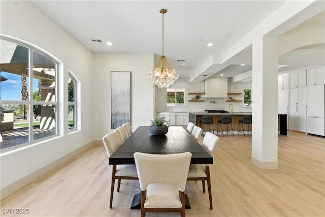 9408 Players Canyon Ct, Las Vegas, NV 89144 - dining space featuring light wood finished floors, recessed lighting, a chandelier, and arched walkways