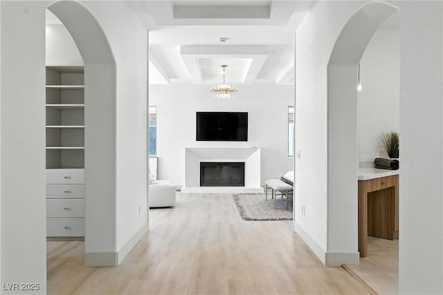 9408 Players Canyon Ct, Las Vegas, NV 89144 - hall featuring a tray ceiling, light wood-type flooring, a chandelier, and plenty of natural light