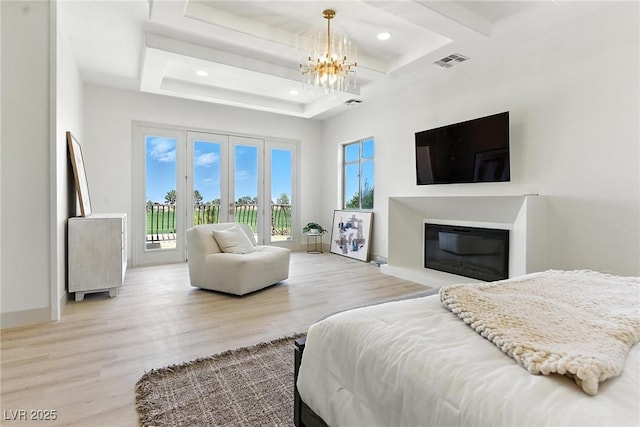 9408 Players Canyon Ct, Las Vegas, NV 89144 - bedroom with access to outside, a chandelier, wood finished floors, recessed lighting, and a glass covered fireplace