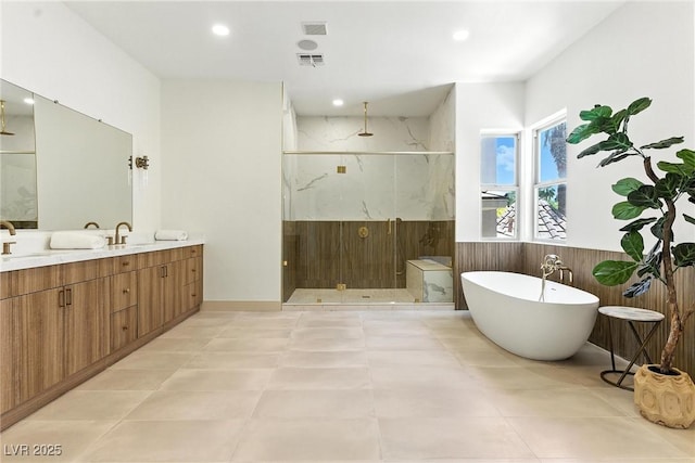 9408 Players Canyon Ct, Las Vegas, NV 89144 - full bath with a shower stall, double vanity, a soaking tub, recessed lighting, and wainscoting