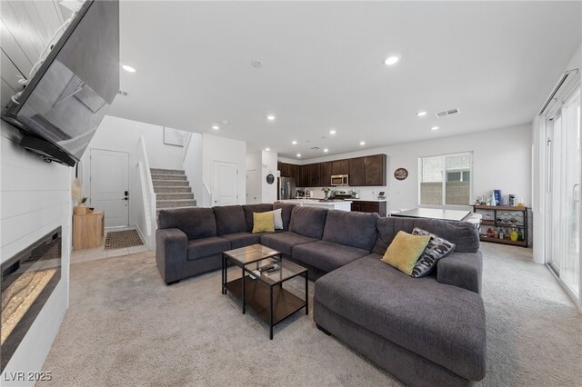 2732 Roman Palm Rd, North Las Vegas, NV 89086 - living area with light carpet, stairway, recessed lighting, and a tiled fireplace