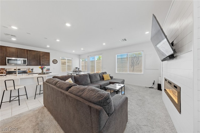 2732 Roman Palm Rd, North Las Vegas, NV 89086 - living area featuring recessed lighting, a fireplace, and light colored carpet