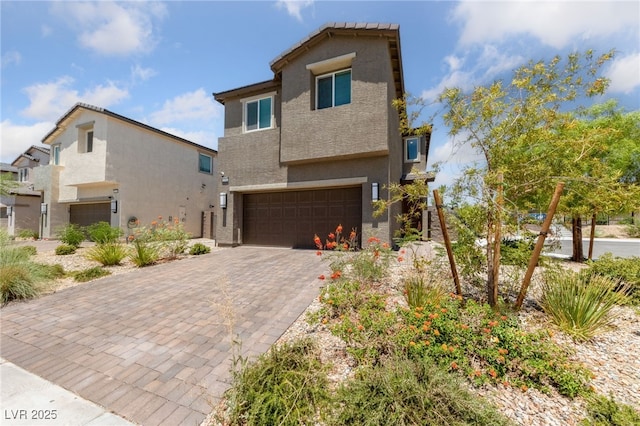 2732 Roman Palm Rd, North Las Vegas, NV 89086 - view of front of home featuring a garage, stucco siding, and decorative driveway