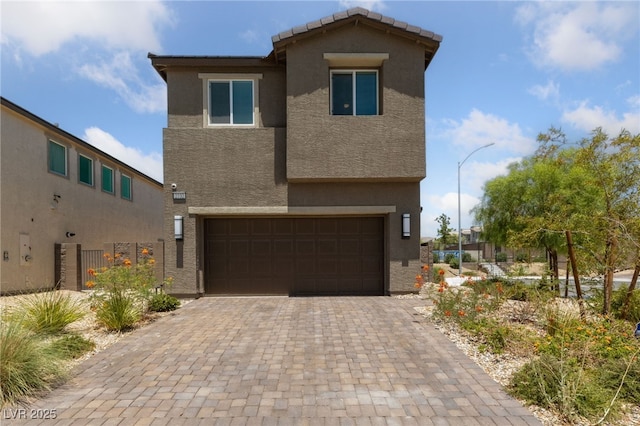2732 Roman Palm Rd, North Las Vegas, NV 89086 - view of front of house featuring stucco siding, an attached garage, and decorative driveway