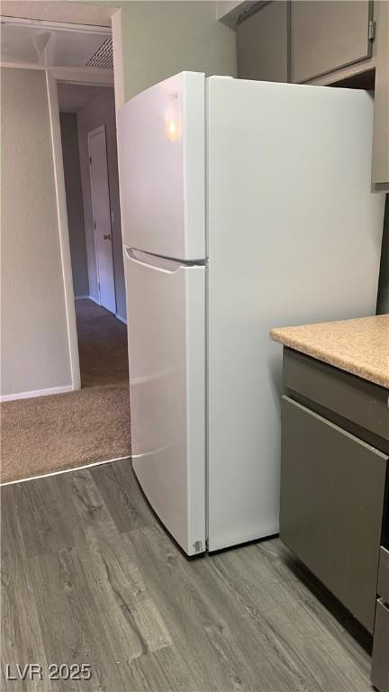 8101 W Flamingo Rd Unit 2110, Las Vegas, NV 89147 - kitchen with freestanding refrigerator, light wood-style floors, light countertops, and gray cabinetry