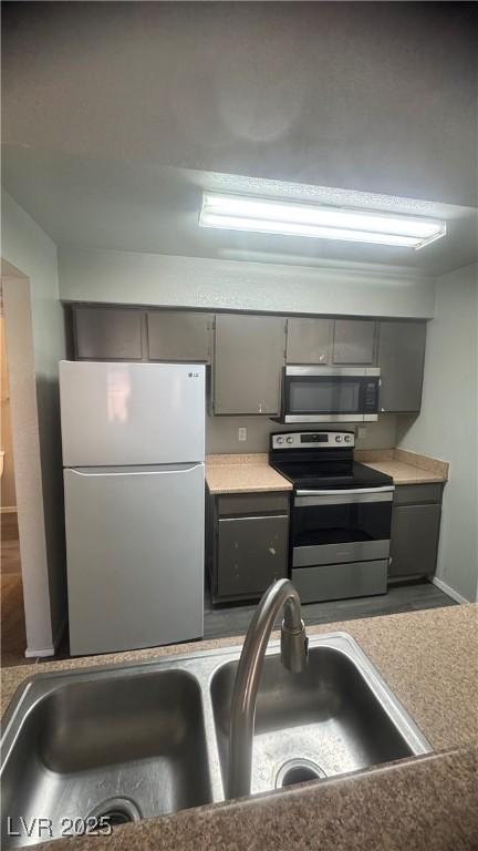8101 W Flamingo Rd Unit 2110, Las Vegas, NV 89147 - kitchen with stainless steel appliances and gray cabinetry