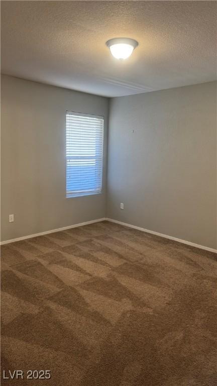 8101 W Flamingo Rd Unit 2110, Las Vegas, NV 89147 - unfurnished room with dark carpet and a textured ceiling