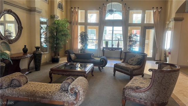 8101 W Flamingo Rd Unit 2110, Las Vegas, NV 89147 - carpeted living area with a towering ceiling and ceiling fan