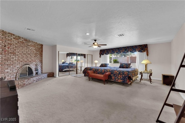 3753 Meadowcrest Dr, Las Vegas, NV 89121 - carpeted bedroom with a textured ceiling, a fireplace, access to outside, and ceiling fan