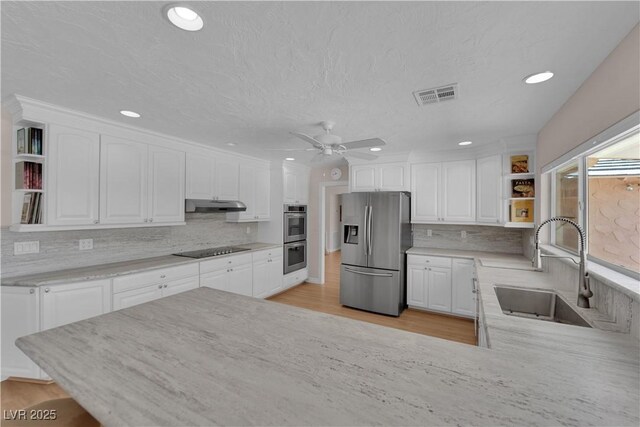3753 Meadowcrest Dr, Las Vegas, NV 89121 - kitchen with appliances with stainless steel finishes, open shelves, under cabinet range hood, ceiling fan, and white cabinets