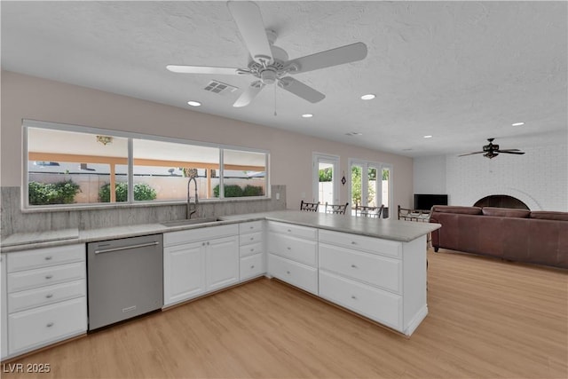 3753 Meadowcrest Dr, Las Vegas, NV 89121 - kitchen with dishwasher, ceiling fan, light wood-style flooring, light countertops, and recessed lighting
