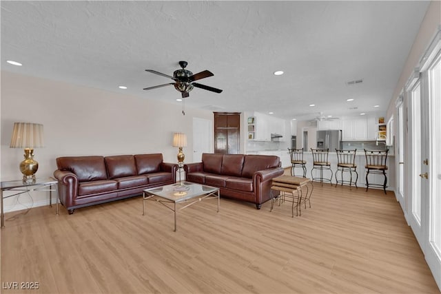 3753 Meadowcrest Dr, Las Vegas, NV 89121 - living room featuring a ceiling fan, recessed lighting, and light wood finished floors