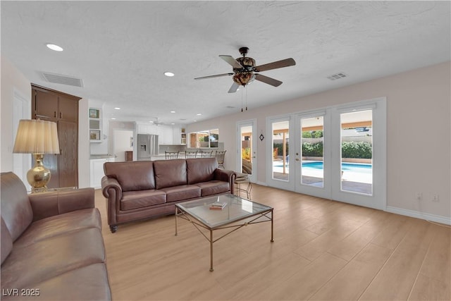 3753 Meadowcrest Dr, Las Vegas, NV 89121 - living area with ceiling fan, light wood-style flooring, recessed lighting, french doors, and a textured ceiling
