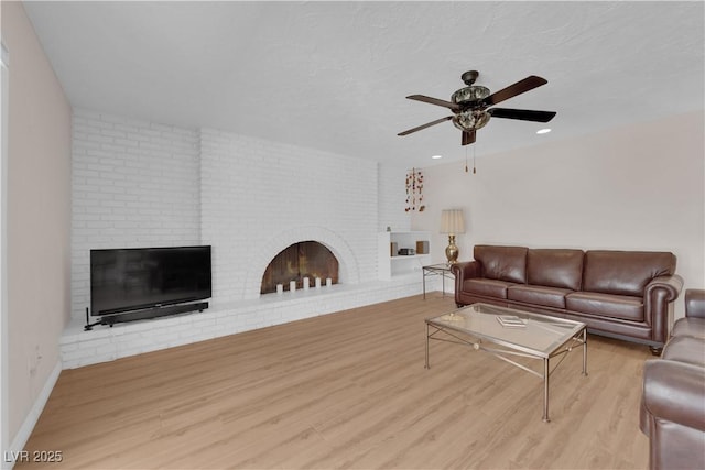 3753 Meadowcrest Dr, Las Vegas, NV 89121 - living area with a brick fireplace, ceiling fan, wood finished floors, and recessed lighting