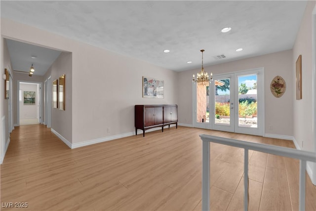 3753 Meadowcrest Dr, Las Vegas, NV 89121 - unfurnished living room featuring a chandelier, light wood-style floors, recessed lighting, and french doors