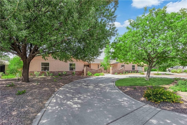 3753 Meadowcrest Dr, Las Vegas, NV 89121 - view of front of house featuring stucco siding and curved driveway