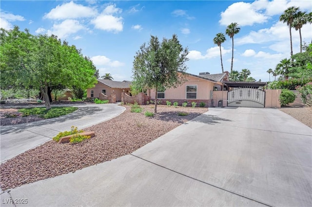 3753 Meadowcrest Dr, Las Vegas, NV 89121 - view of front of house with curved driveway, a gate, and stucco siding