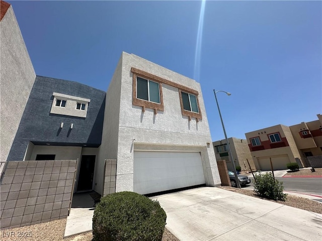 6450 Cinnamon Hazlenut St, North Las Vegas, NV 89084 - view of front of property with an attached garage, driveway, and stucco siding
