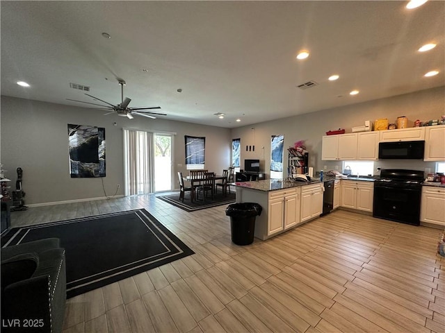 6450 Cinnamon Hazlenut St, North Las Vegas, NV 89084 - kitchen featuring black appliances, recessed lighting, a peninsula, dark countertops, and a ceiling fan