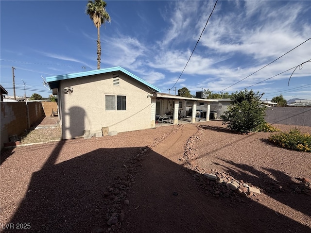 4567 S Nellis Blvd, Las Vegas, NV 89121 - back of property with stucco siding, a fenced backyard, and a patio