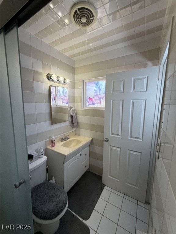 4567 S Nellis Blvd, Las Vegas, NV 89121 - half bathroom with tile walls, tile patterned flooring, and vanity
