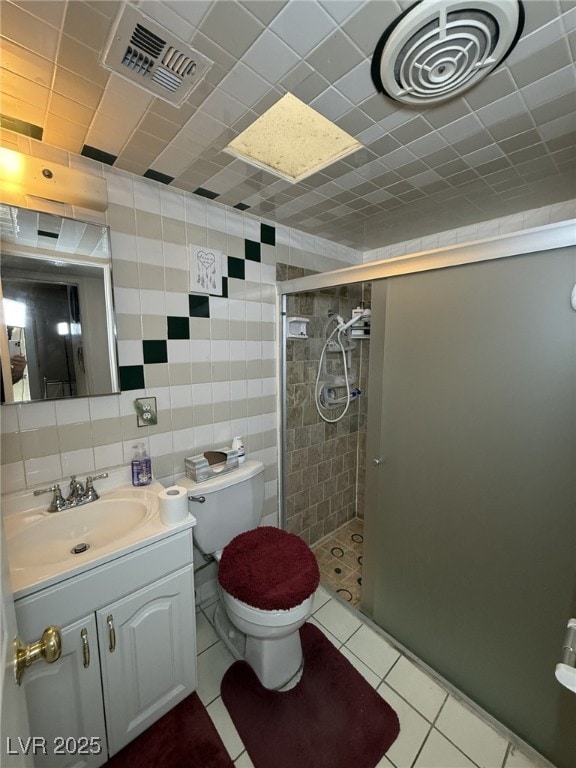 4567 S Nellis Blvd, Las Vegas, NV 89121 - bathroom with a shower stall, vanity, tile walls, and tile patterned flooring