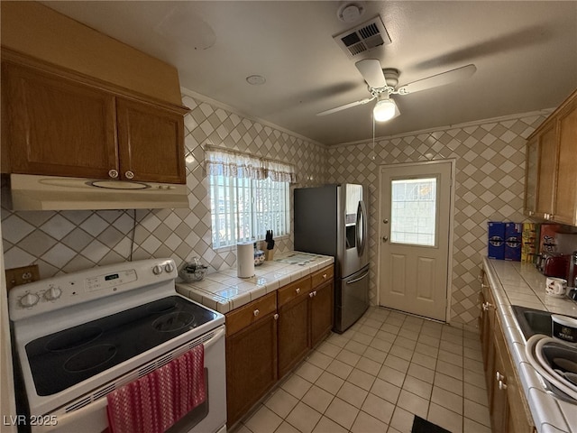 4567 S Nellis Blvd, Las Vegas, NV 89121 - kitchen featuring white electric range, ventilation hood, tile counters, stainless steel fridge with ice dispenser, and light tile patterned floors