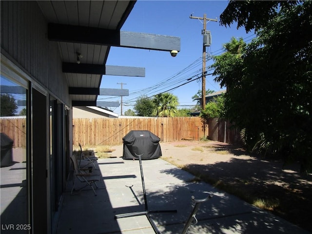 6409 Burgundy Way, Las Vegas, NV 89107 - fenced backyard featuring grilling area and a patio