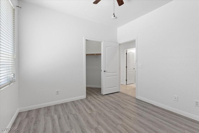 820 Peach Ave, North Las Vegas, NV 89032 - unfurnished bedroom featuring light wood-style floors, a spacious closet, a closet, and a ceiling fan