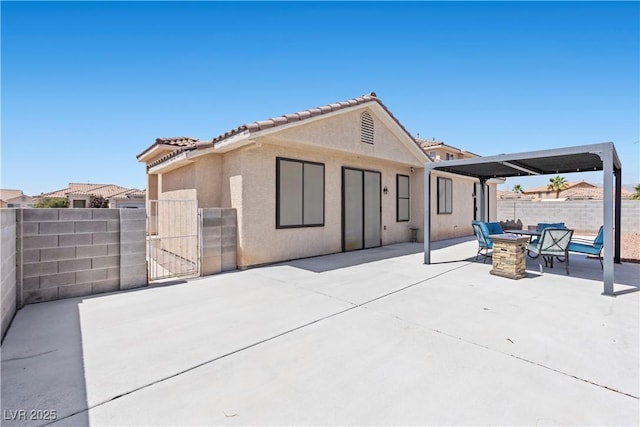 820 Peach Ave, North Las Vegas, NV 89032 - back of house featuring a gate, a patio area, and stucco siding
