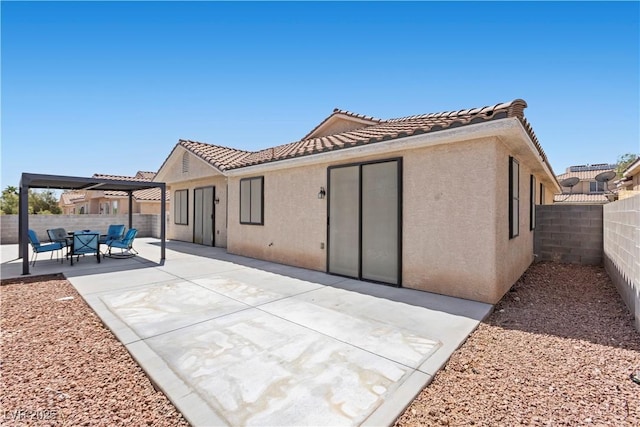 820 Peach Ave, North Las Vegas, NV 89032 - rear view of house with stucco siding, a tiled roof, a patio, and a fenced backyard