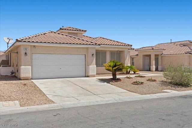 820 Peach Ave, North Las Vegas, NV 89032 - mediterranean / spanish-style house with an attached garage, driveway, stucco siding, and a tile roof