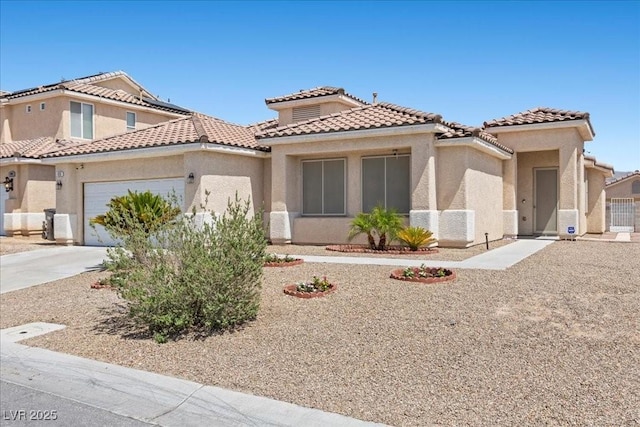 820 Peach Ave, North Las Vegas, NV 89032 - mediterranean / spanish-style home featuring an attached garage, stucco siding, and concrete driveway