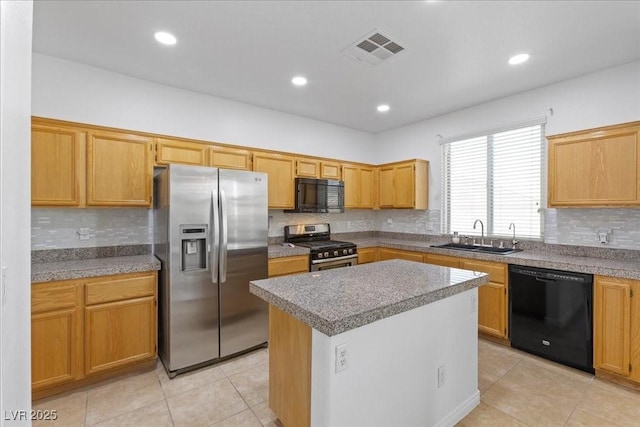 820 Peach Ave, North Las Vegas, NV 89032 - kitchen with black appliances, light tile patterned floors, backsplash, a center island, and recessed lighting