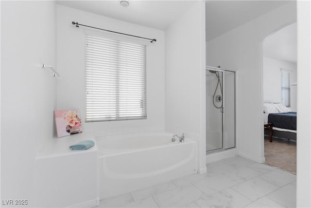 820 Peach Ave, North Las Vegas, NV 89032 - ensuite bathroom with a bath, marble look tiles, and a shower stall