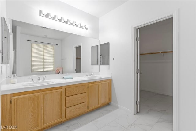 820 Peach Ave, North Las Vegas, NV 89032 - full bathroom featuring marble look tile flooring, double vanity, and a walk in closet