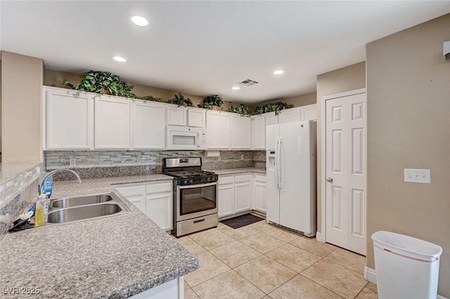 967 Coronado Peak Ave, Las Vegas, NV 89183 - kitchen with white appliances, tasteful backsplash, white cabinetry, light countertops, and light tile patterned flooring
