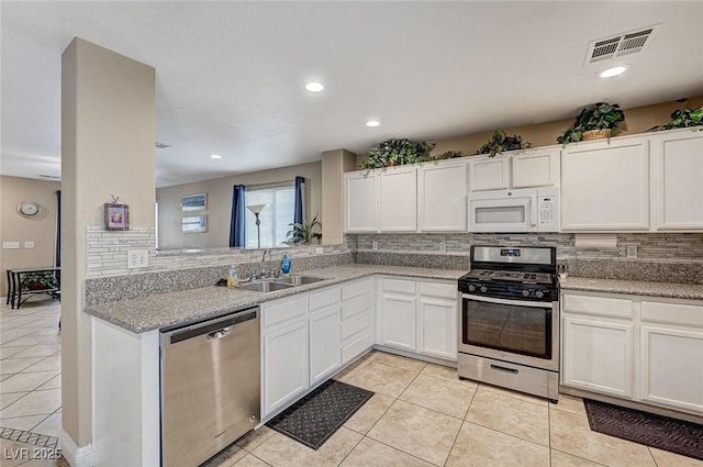 967 Coronado Peak Ave, Las Vegas, NV 89183 - kitchen featuring stainless steel appliances, backsplash, light tile patterned flooring, and recessed lighting