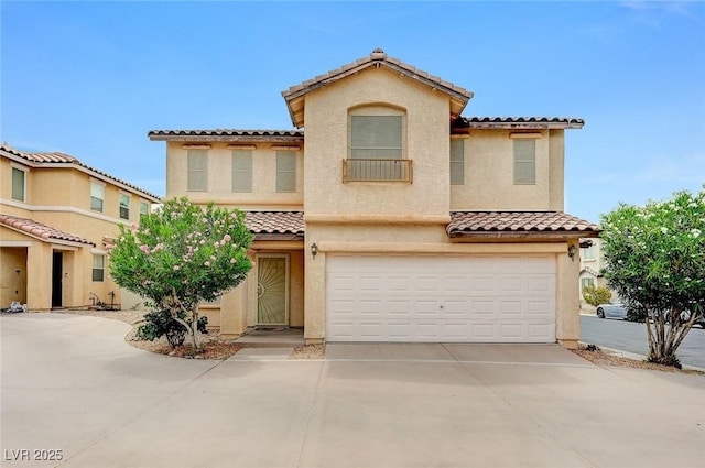 967 Coronado Peak Ave, Las Vegas, NV 89183 - mediterranean / spanish-style home featuring a tiled roof, stucco siding, an attached garage, and driveway