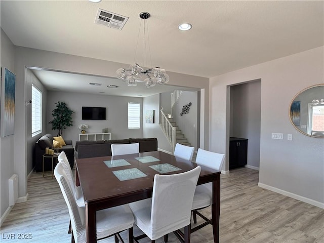 9604 Vital Crest St, Las Vegas, NV 89123 - dining area featuring a chandelier, stairway, light wood-type flooring, plenty of natural light, and recessed lighting